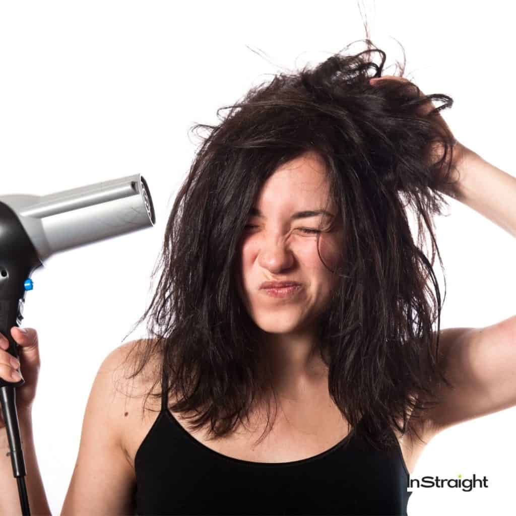 lady drying her wet hair but do hair dryer cause hair loss?