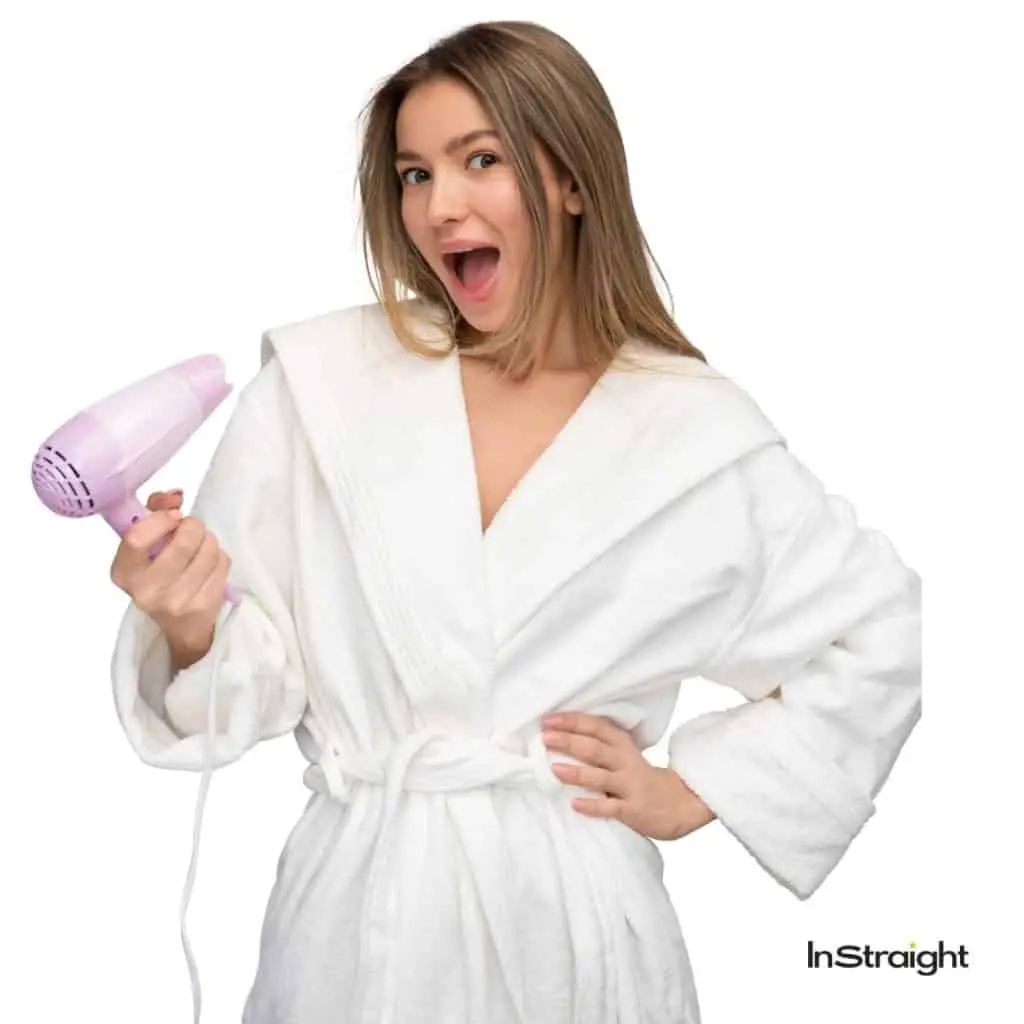 lady in robe holding a blow dryer