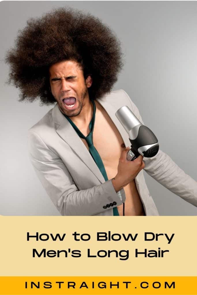 man with long curly hair blow drying his hair