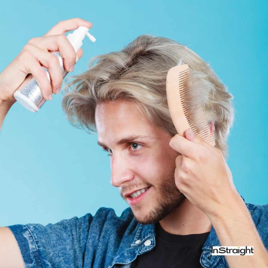 man putting heat protectant to his hair