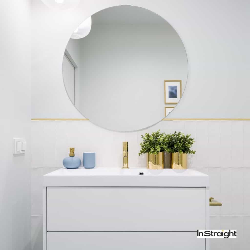 round bathroom mirror on top of a table