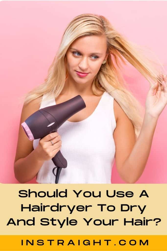 woman drying her hair using a blow dryer