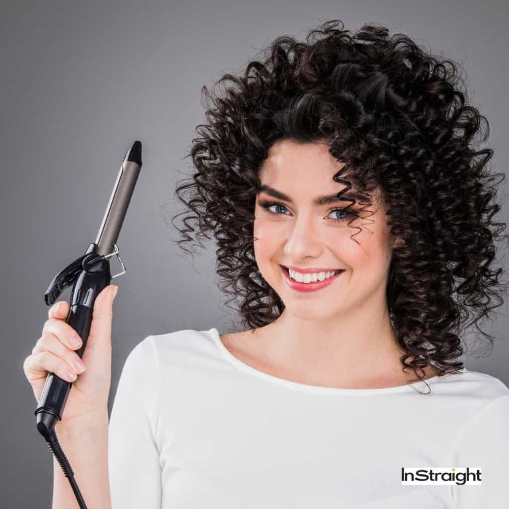 woman holding a curling iron