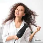 lady blow drying her natural curly hair