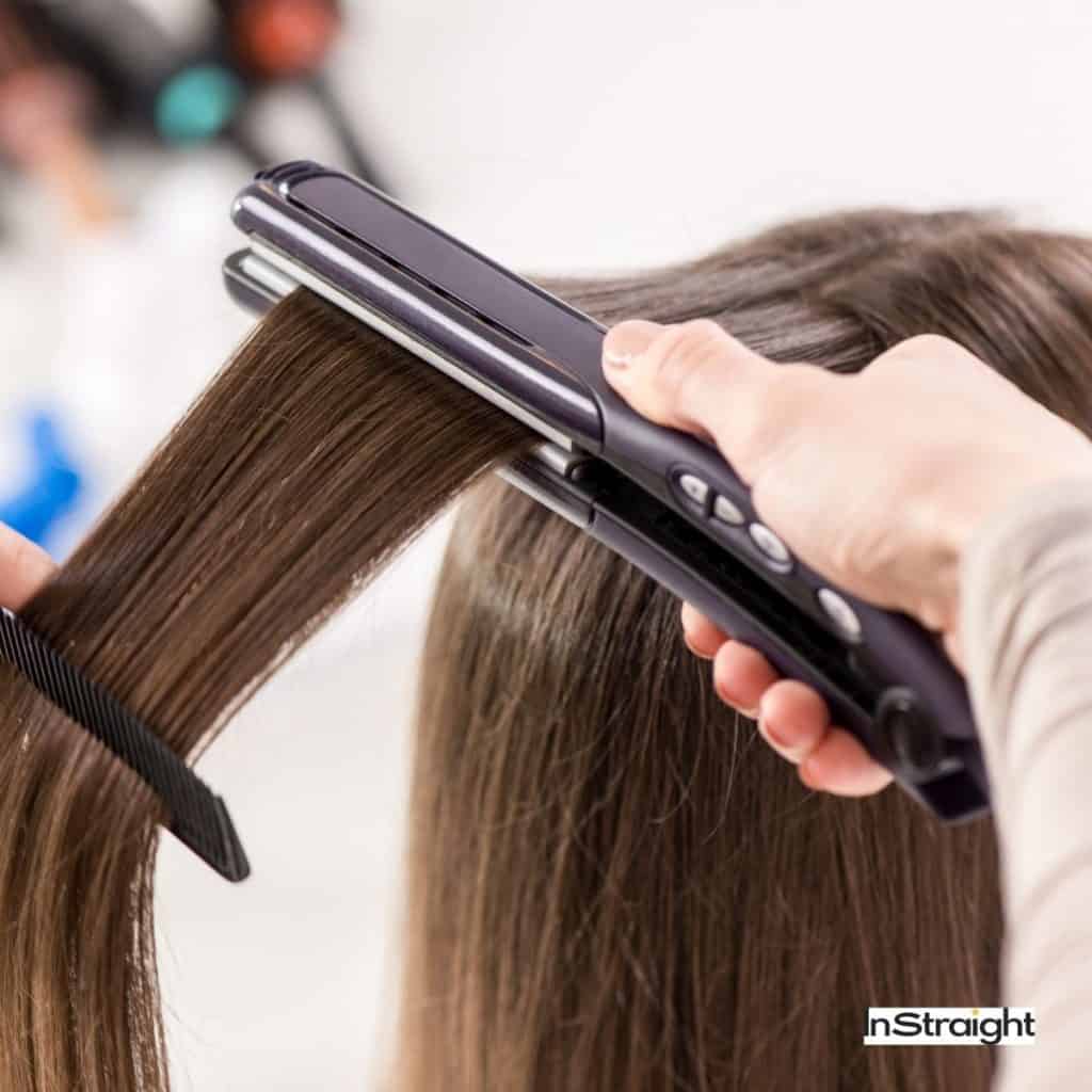 hair straightener being used on a lady's hair