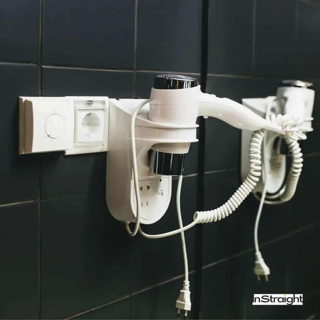 plugged hairdryer on the bathroom