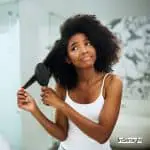 lady struggling on how to blow dry black hair