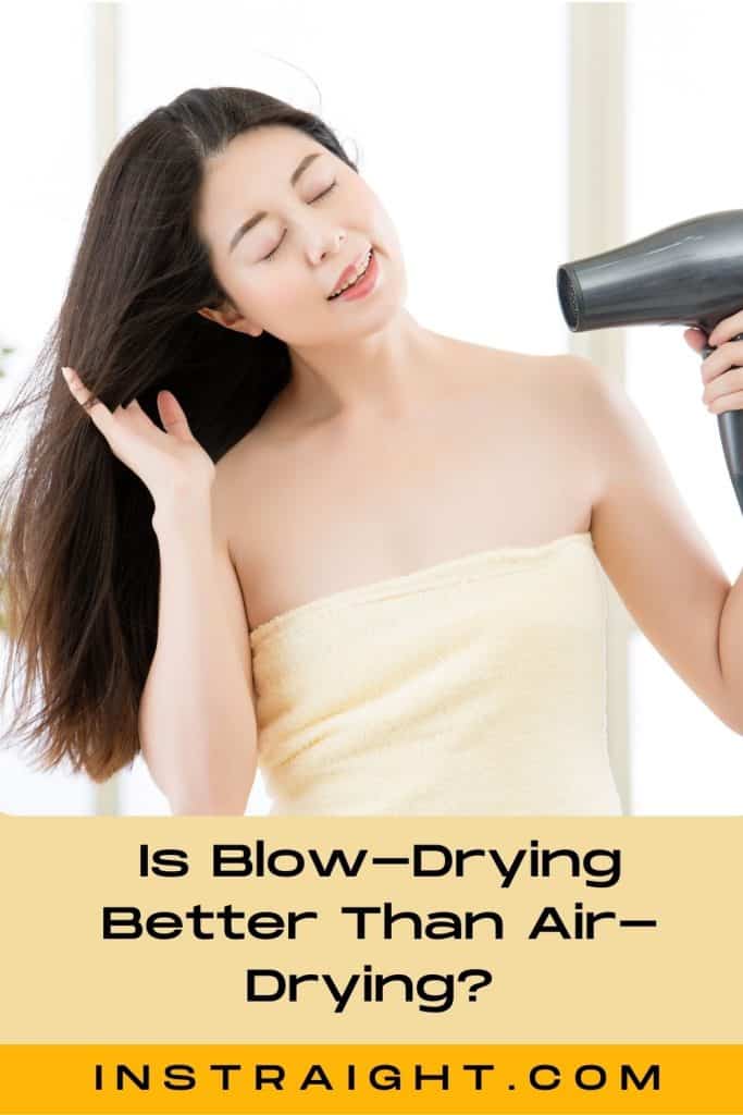 an Asian woman blow drying her hair after showering