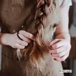 lady braiding her long hair
