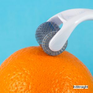 dermaroller on unpeeled orange under Does Dermarolling Vanish Your Stretch Marks Entirely?