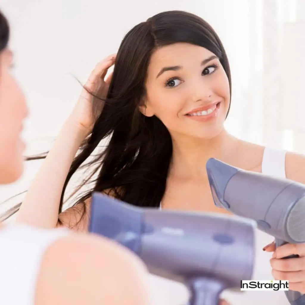 lady drying her hair using one of the best t3 hair dryers