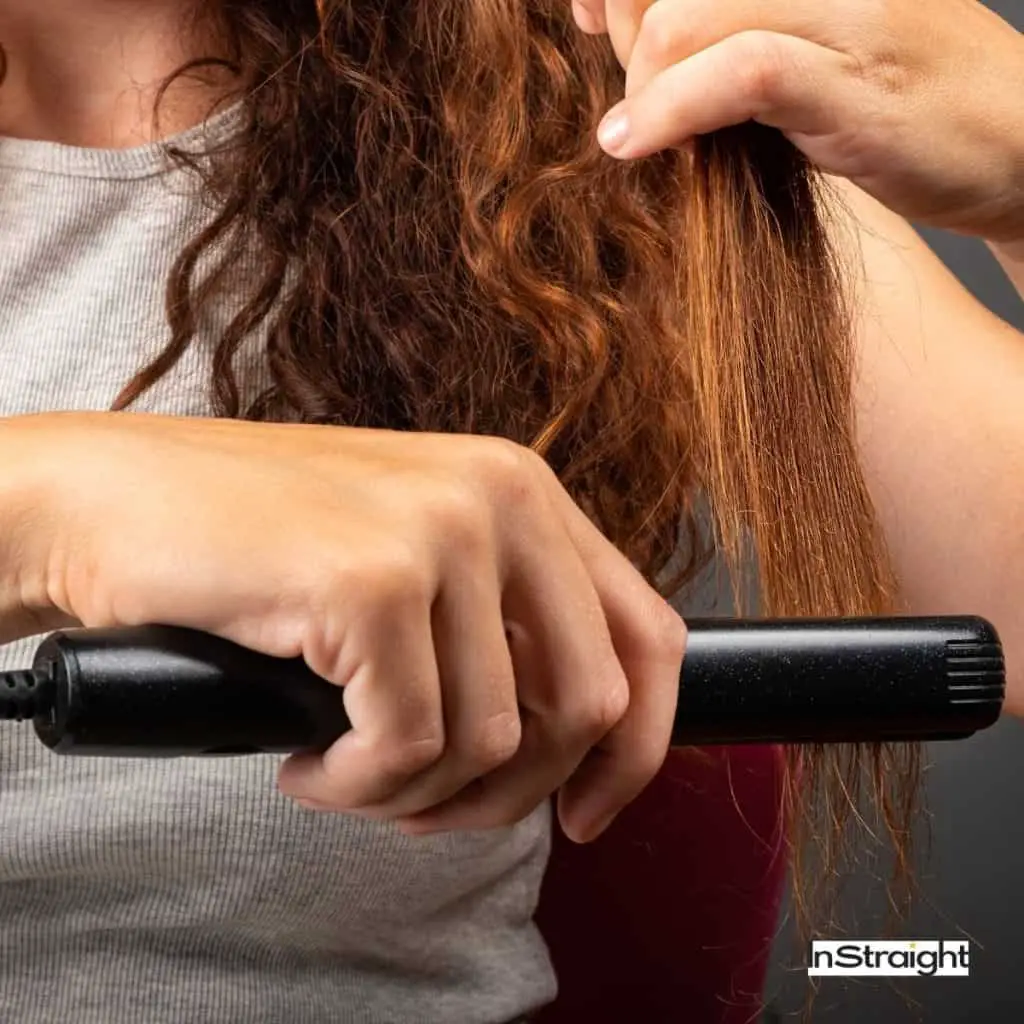 lady straightening her curly hair