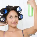 lady spraying her hair with curlers