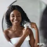woman spraying hair protectant