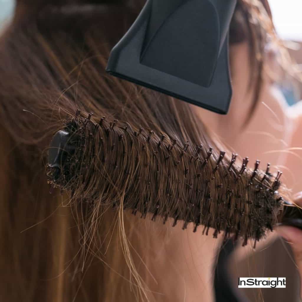blow drying hair with the help of round brush