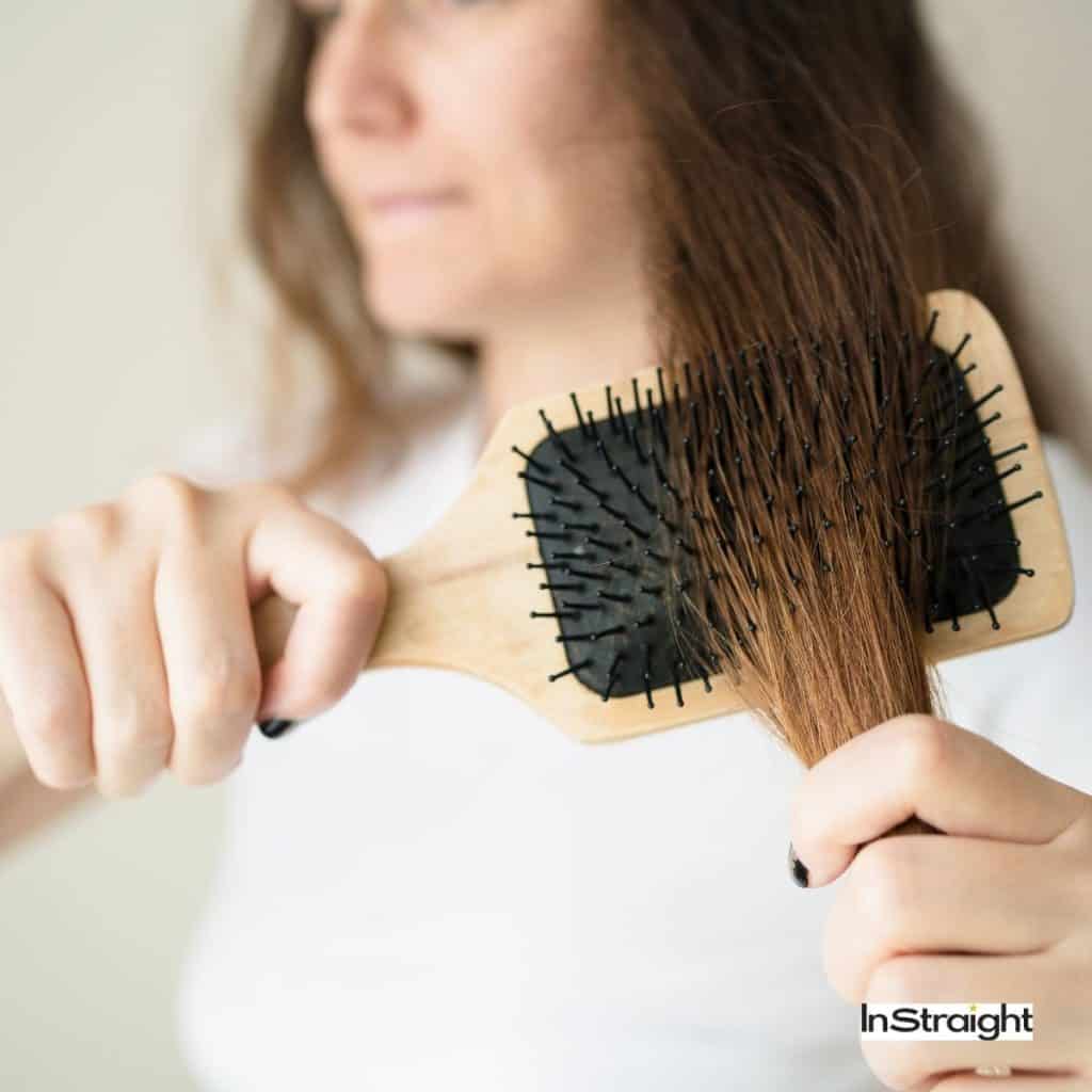 lady brushing her damaged hair