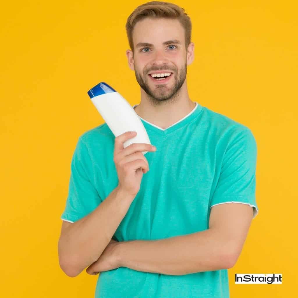 guy holding a mild shampoo