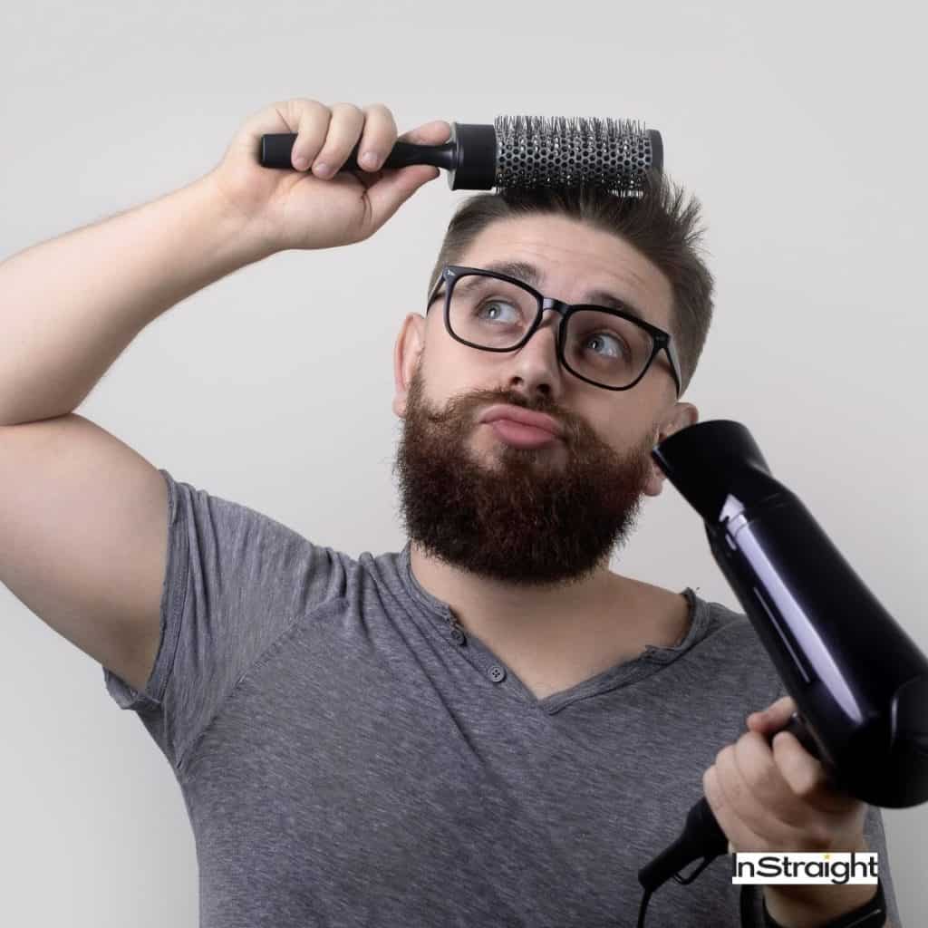 man straightening his hair