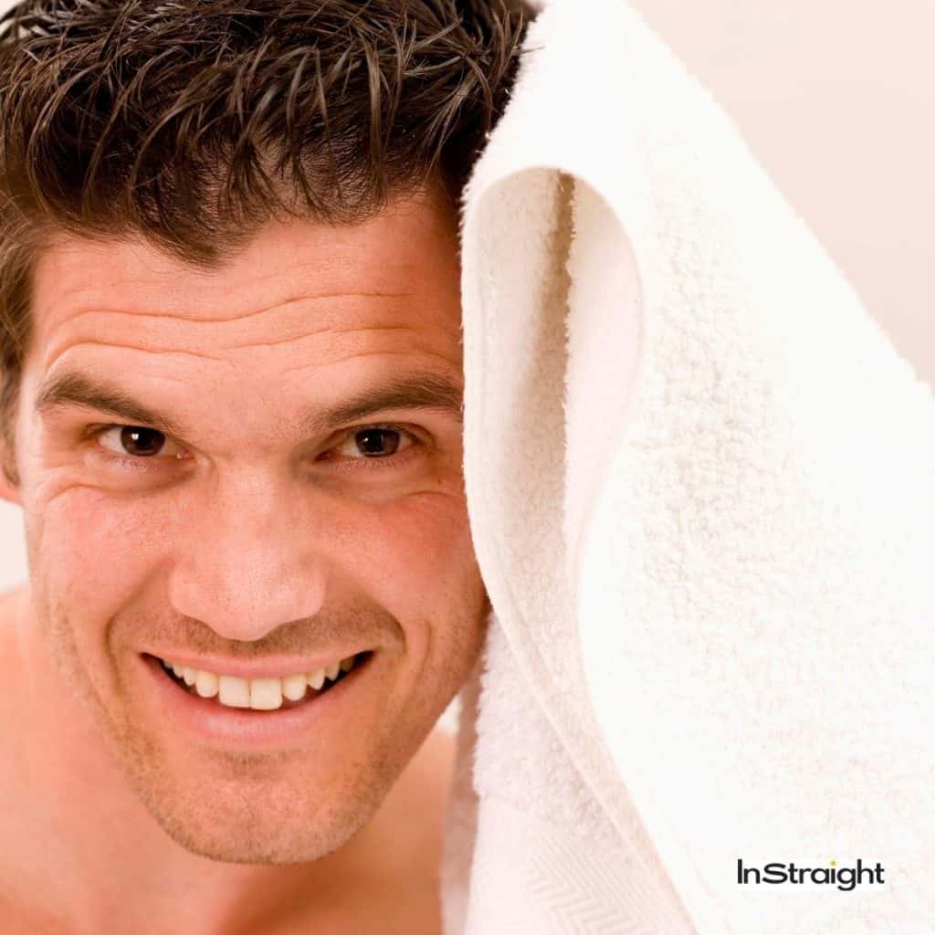 smiling man towel drying hair under title how to towel dry men hair