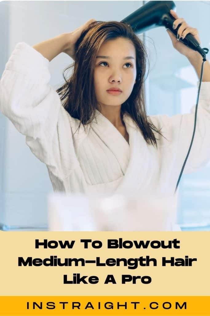 a lady blowdrying her medium length hair