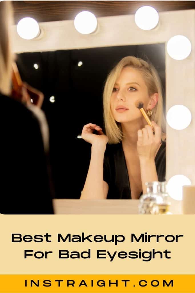 lady with blonde hair applying makeup in front of a lighted mirror