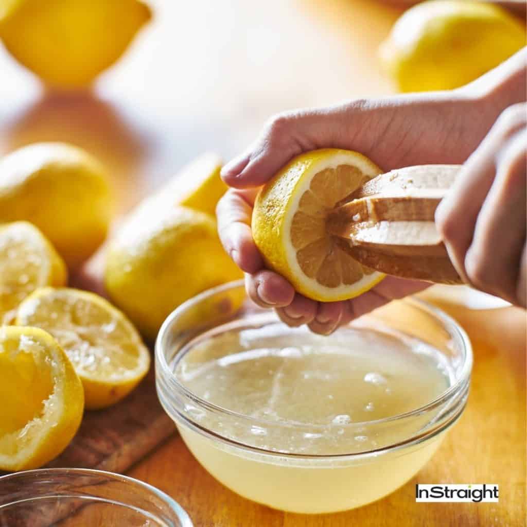 a woman making a lemon juice
