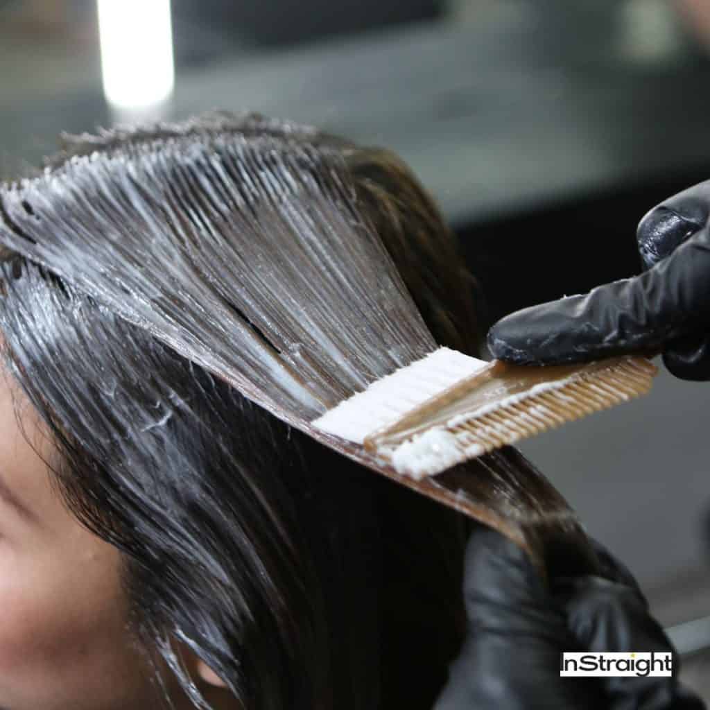 A chemical being applied on hair under title Keratin vs. Relaxer