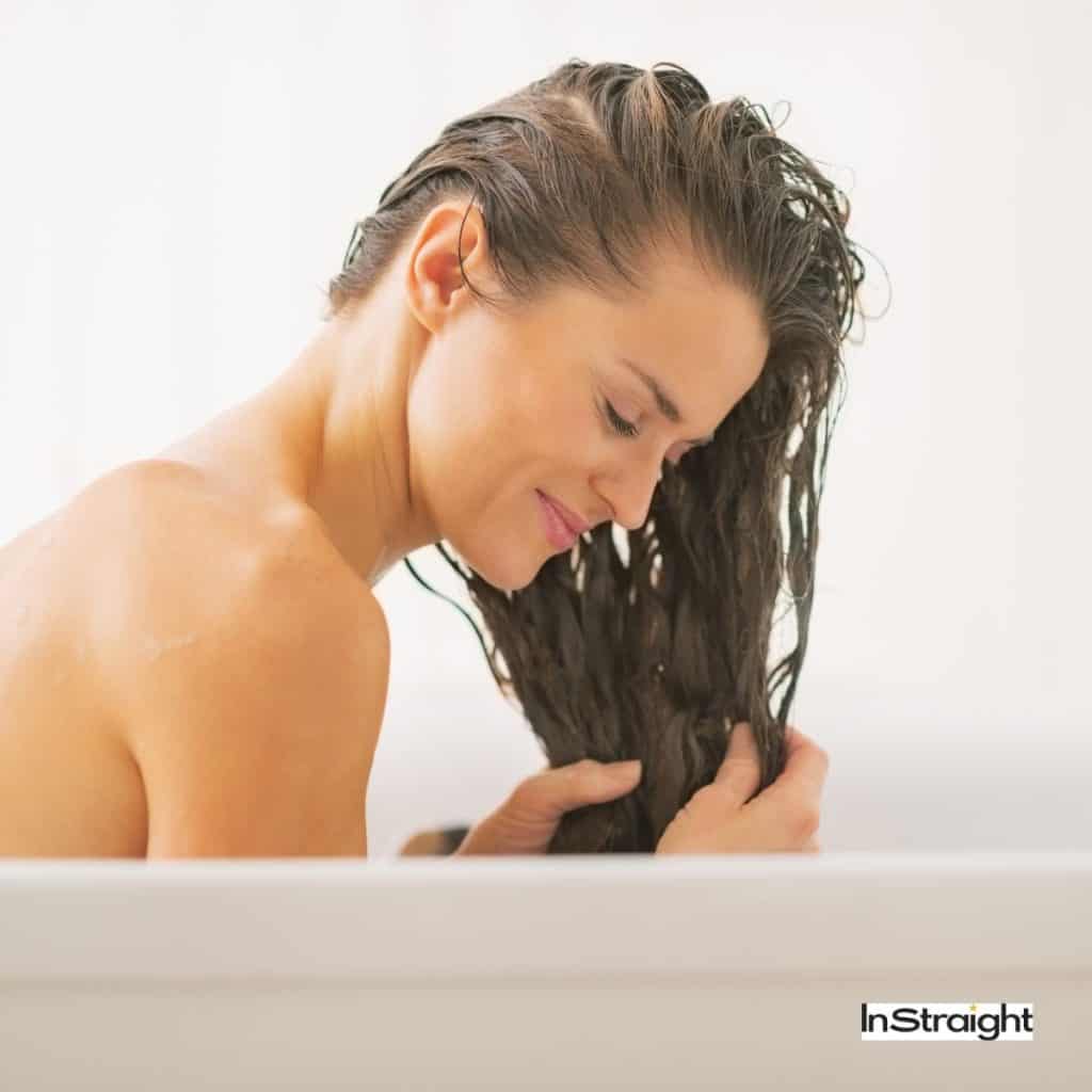 lady washing her hair in a bathtub