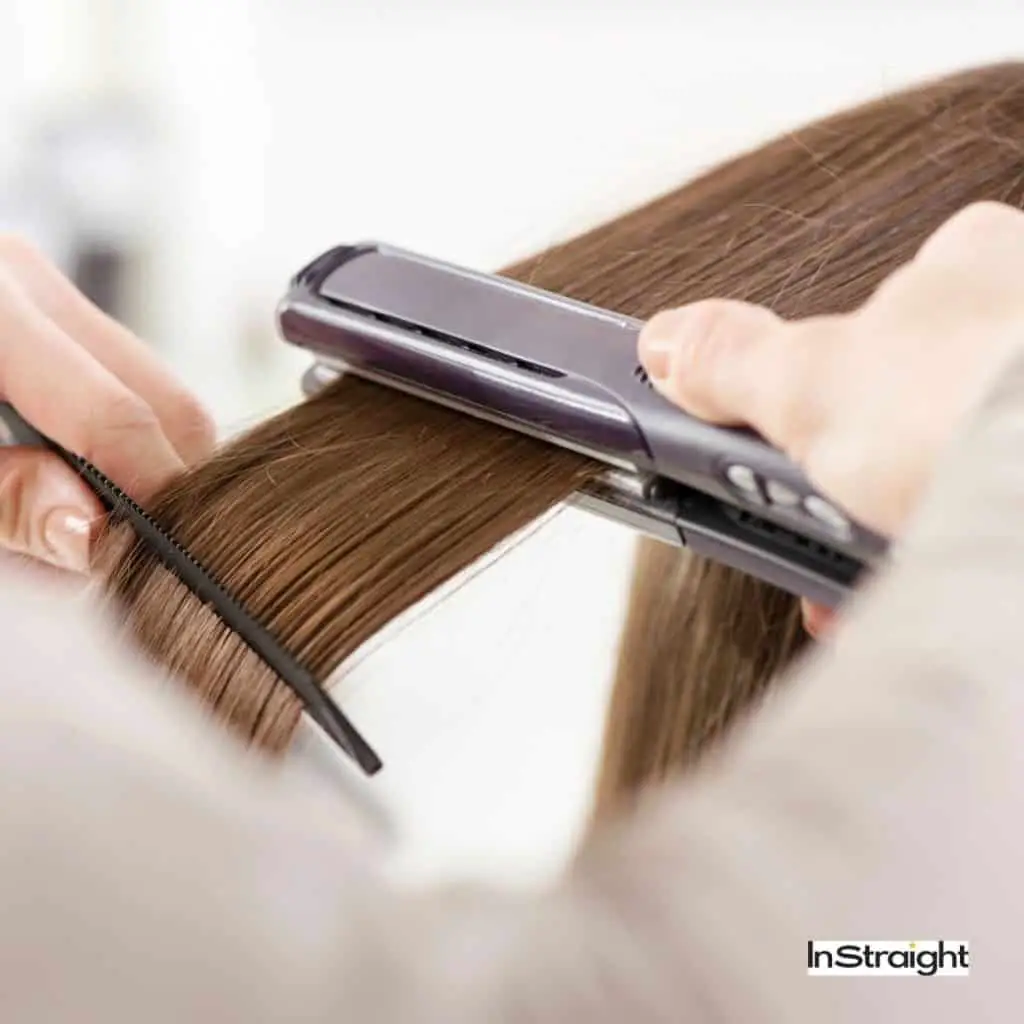 woman using hair straightener but do hair straighteners damage hair 